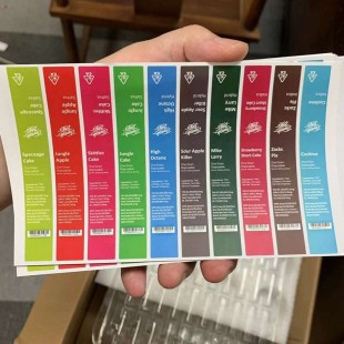 Jungle Boys Vape Pen flavor stickers held by a hand